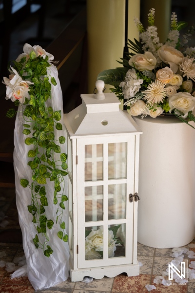 Decorations for a wedding ceremony in Curacao with flowers and lighting elements near the altar