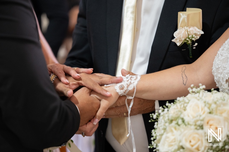 Couple exchanges vows during wedding ceremony in Curacao with guests surrounding them in a warm moment of love and connection