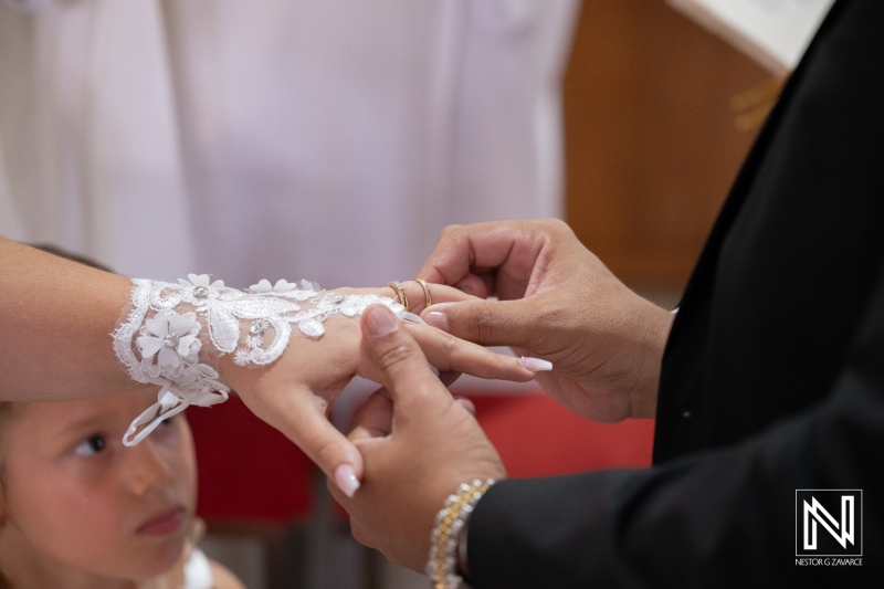 Couple exchanges wedding rings in a ceremony in Curacao under bright lights