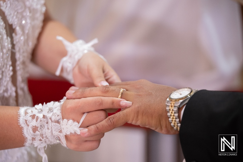 Couple exchanges wedding rings during ceremony in Curacao on a sunny afternoon