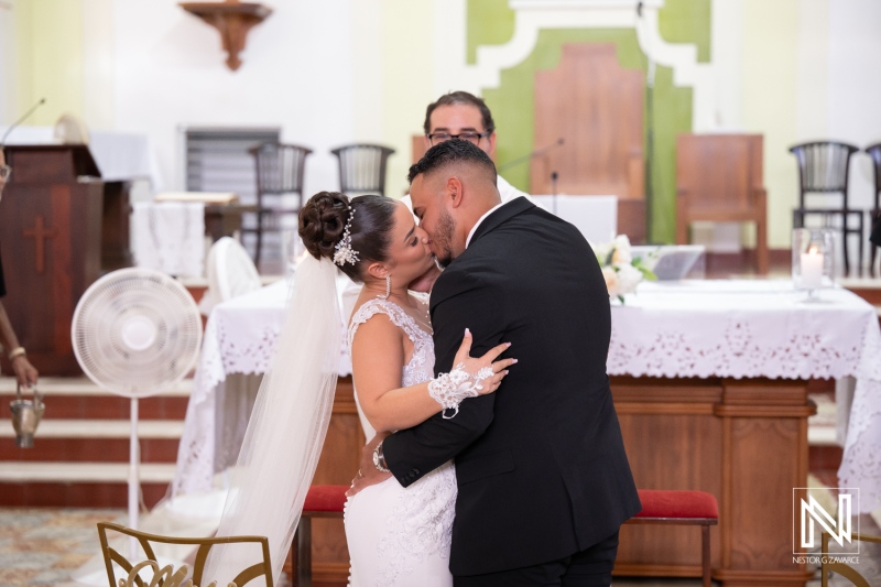 Wedding ceremony in Curacao with couple in a close embrace at the altar during their vows