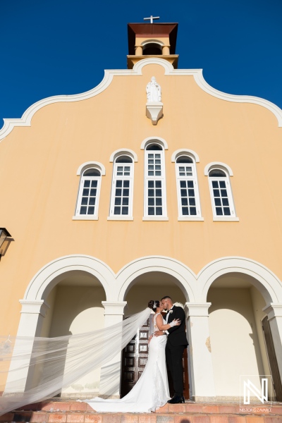 Wedding ceremony in Curacao under bright sky beside historic church