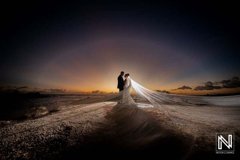 Couple shares moment on the beach during wedding ceremony in Curacao at sunset