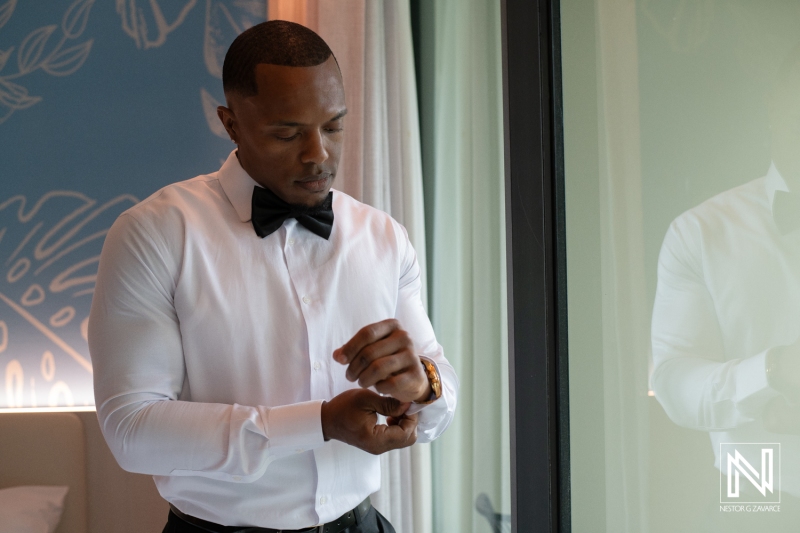 Groom getting into attire