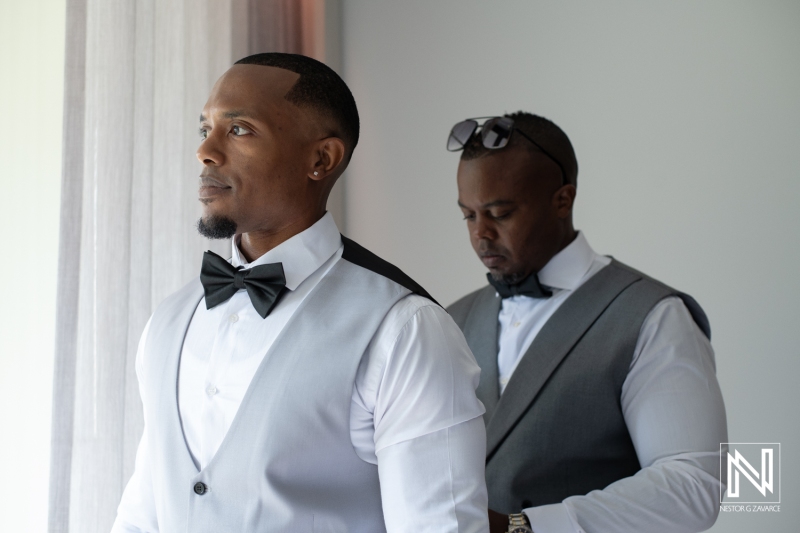 Groom getting into attire