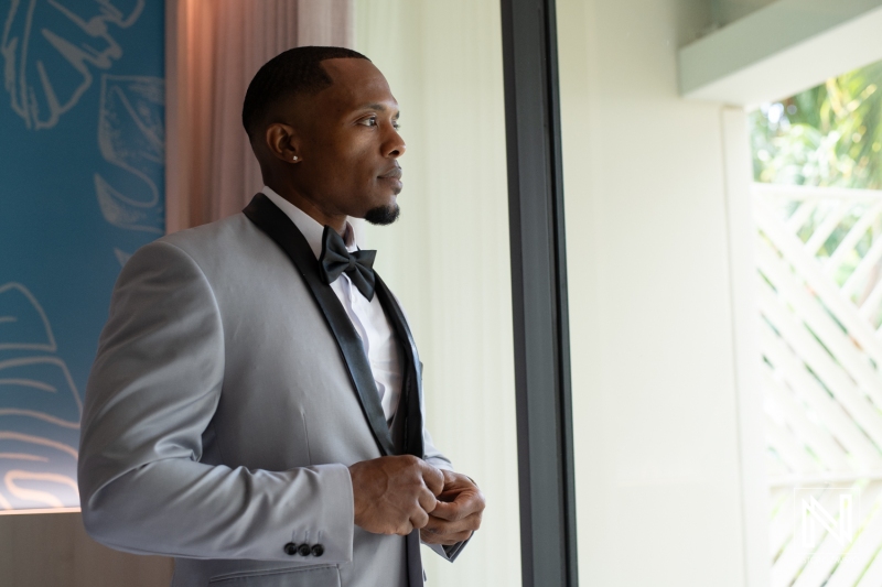 Groom getting into attire