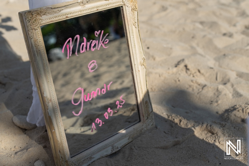 Wedding celebration at Daaibooi Beach in Curacao with personalized mirror decor capturing the moment