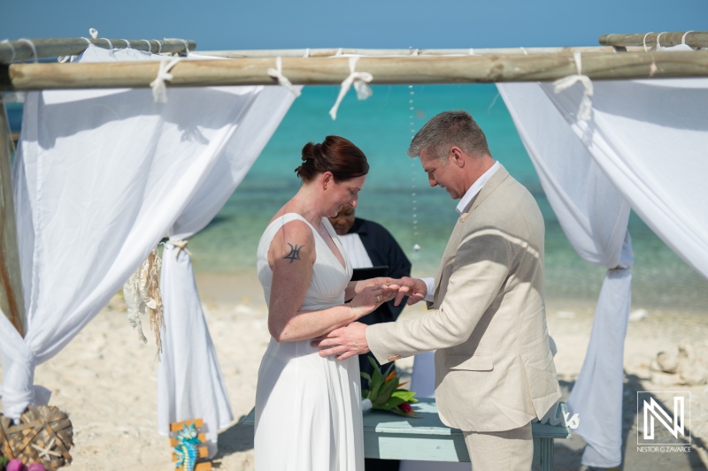 Couple exchanges vows during a romantic wedding ceremony at Daaibooi Beach in Curacao
