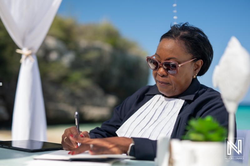Ceremony planner preparing details for a wedding at Daaibooi Beach in Curacao under the tropical sun
