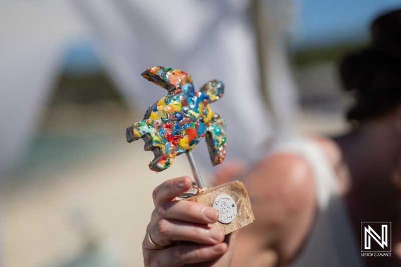Colorful turtle cake topper showcased during a wedding celebration at Daaibooi Beach in Curacao