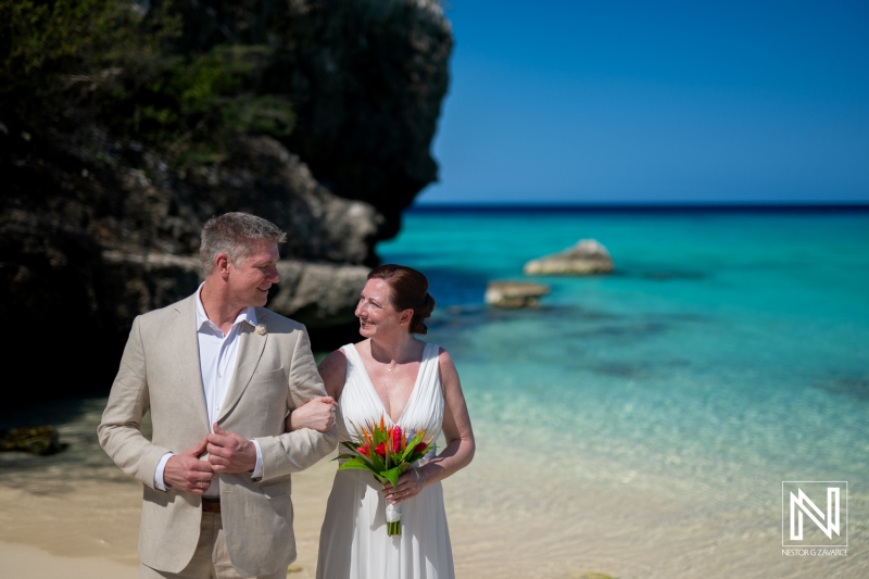 Couple enjoys a romantic wedding ceremony at Daaibooi Beach in Curacao with stunning turquoise waters and a beautiful landscape