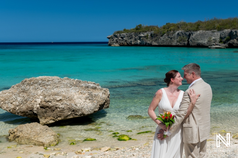 Couple exchanges vows at Daaibooi Beach in Curacao, celebrating love in a picturesque tropical paradise