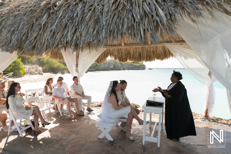 Wedding ceremony at Karakter in Curacao overlooking the sea with guests seated on the beach