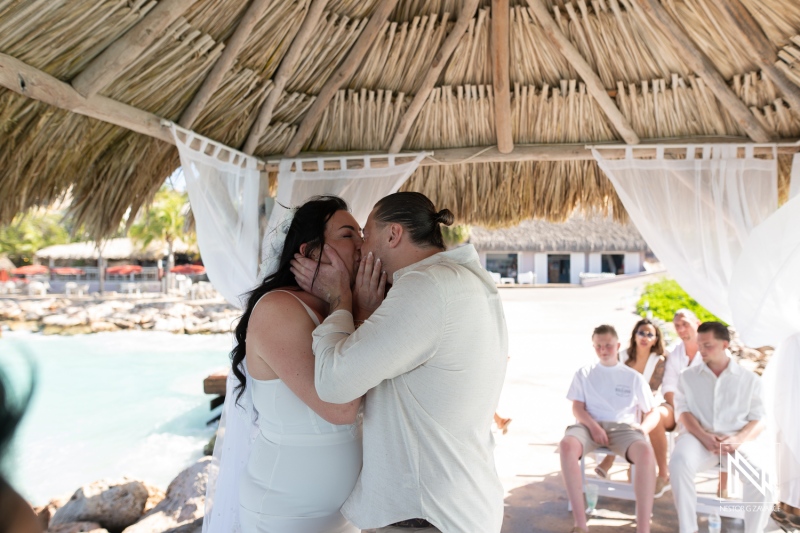 Couple exchanges vows and shares kiss during wedding ceremony at Karakter in Curacao