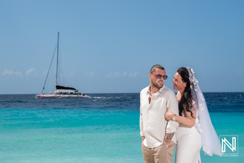 Couple enjoys wedding at Karakter in Curacao with view of boat in background