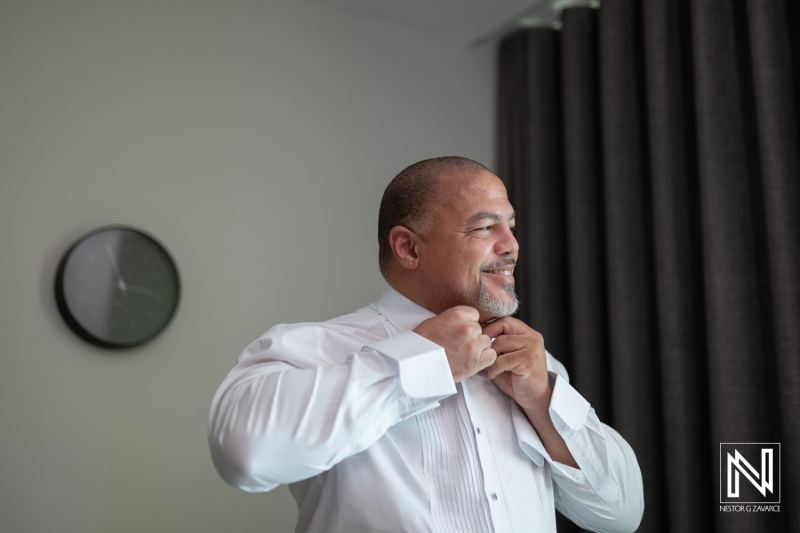 Groom prepares for wedding at Avila Beach Hotel in Curacao with joyful anticipation