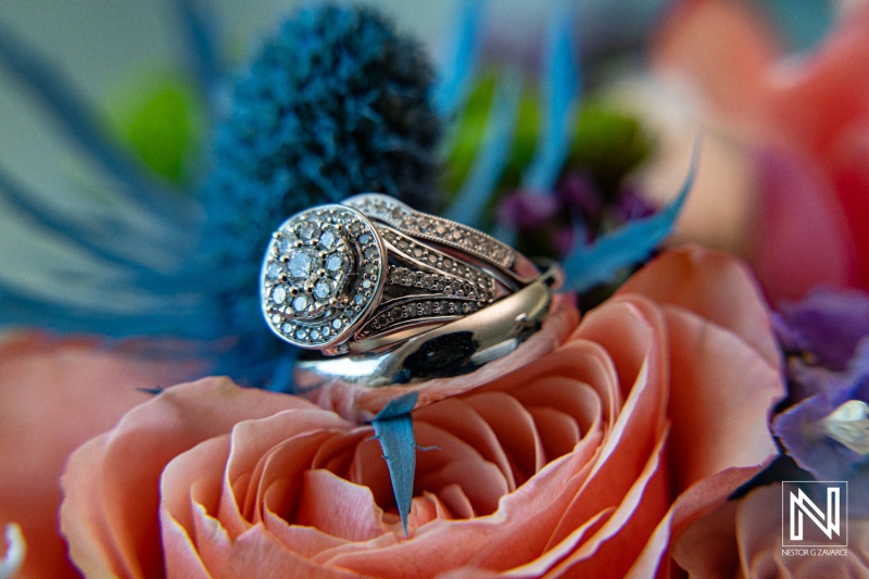 Beautiful wedding ring resting on vibrant roses at Avila Beach Hotel in Curacao during a romantic ceremony