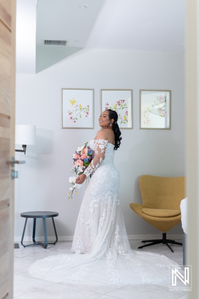 Bridal moments in Curacao at Avila Beach Hotel with stunning floral bouquet and elegant lace gown