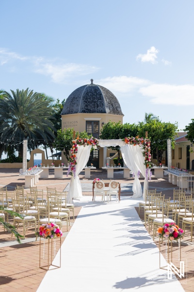 Beautiful wedding setup at Avila Beach Hotel in Curacao with vibrant floral decorations and a picturesque backdrop