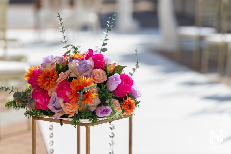 Vibrant floral arrangement at outdoor wedding ceremony in Curacao near Avila Beach Hotel during sunny afternoon