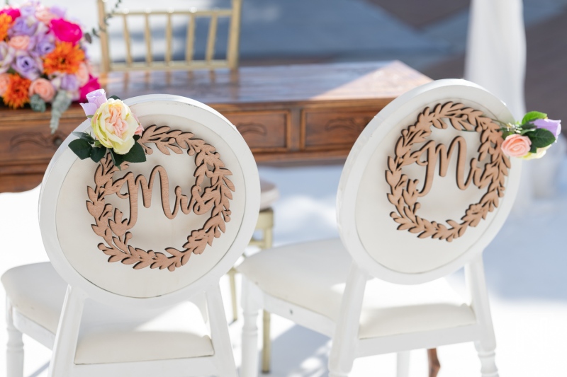 Elegant wedding chairs decorated with floral accents ready for a ceremony at Avila Beach Hotel in Curacao