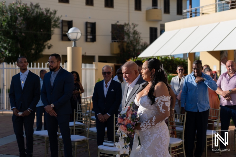Couple celebrates wedding at Avila Beach Hotel in Curacao surrounded by friends and family during a beautiful sunset ceremony