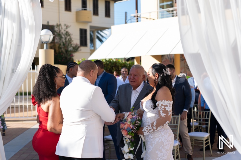 Intimate wedding ceremony at Avila Beach Hotel in Curacao with family and friends gathered in a beautiful setting