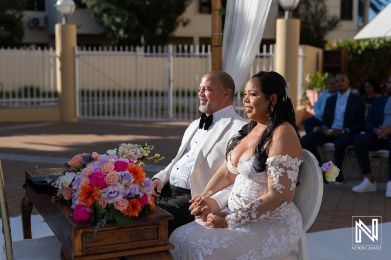 Couple celebrates their wedding ceremony at Avila Beach Hotel in Curacao surrounded by beautiful decorations and an outdoor setting