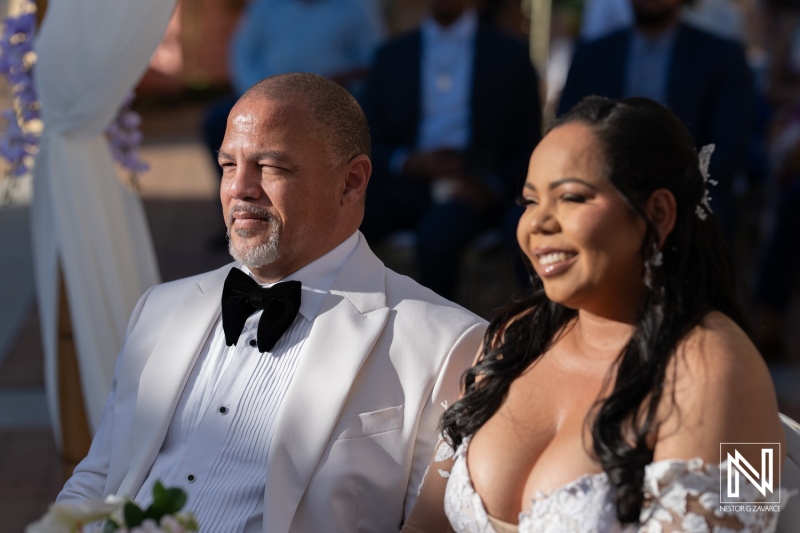 Beautiful outdoor wedding ceremony at Avila Beach Hotel in Curacao with a happy couple and guests enjoying the moment