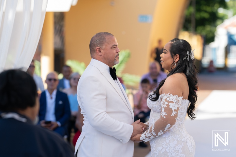 Couple exchanges vows during a beautiful wedding ceremony at Avila Beach Hotel in Curacao, celebrating love in a picturesque setting