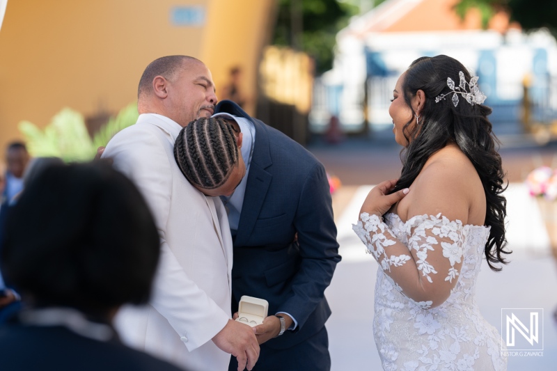 Wedding ceremony at Avila Beach Hotel in Curacao with emotional moments between the groom and best man