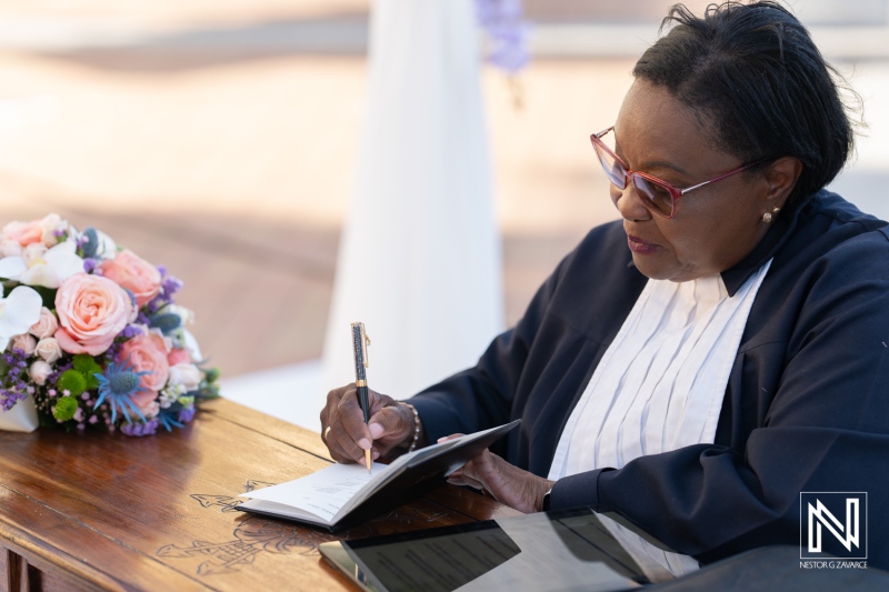 Ceremony officiant signing marriage license at Avila Beach Hotel in Curacao during a picturesque wedding celebration