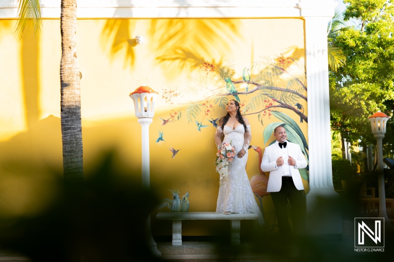 Celebrating love at Avila Beach Hotel in Curacao with a stunning wedding couple against a vibrant mural backdrop