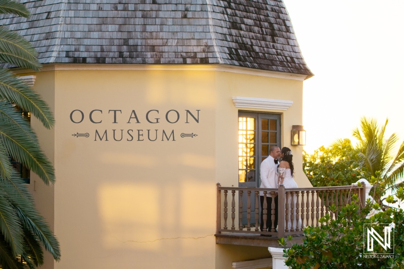 Couple celebrates love at sunset on the balcony of Avila Beach Hotel, Curacao during their wedding ceremony