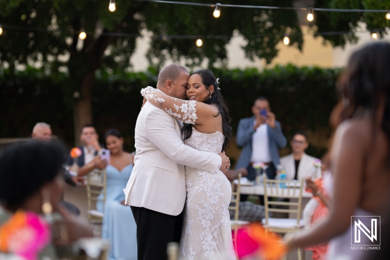 Beautiful wedding celebration at Avila Beach Hotel in Curacao, capturing an intimate moment between the bride and groom surrounded by loved ones