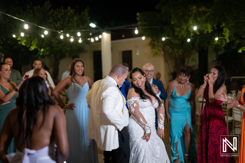 Wedding celebration at Avila Beach Hotel in Curacao with dancing and joyful guests under string lights