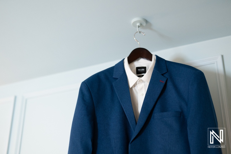 Elegant blue suit hung in preparation for a wedding at Renaissance Wind Creek Curacao Resort