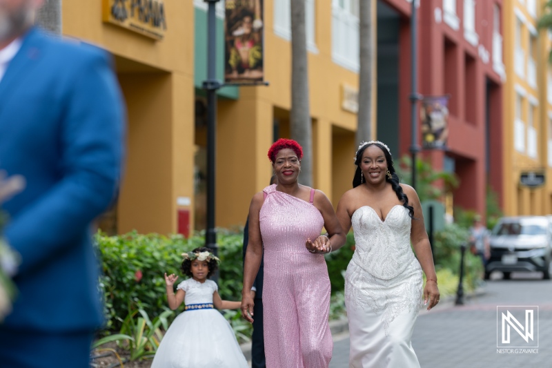 Bridesmaids accompany the bride in colorful surroundings at a wedding in Curacao