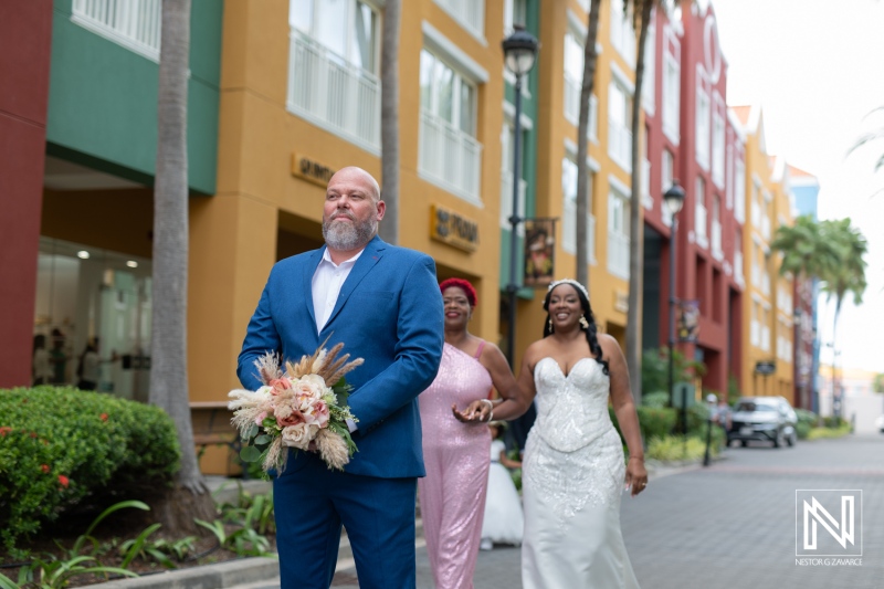Couple and bridal party walking in the vibrant streets of Curacao, celebrating a wedding at Renaissance Wind Creek Curacao Resort