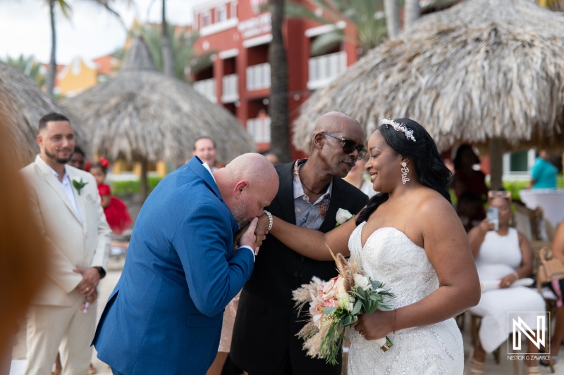 Wedding ceremony at Renaissance Wind Creek Curacao Resort with heartfelt moments under palm trees and beach