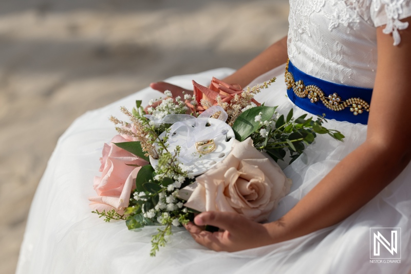 Beautiful bridal bouquet holds wedding rings in Curacao setting at Renaissance Wind Creek Curacao Resort