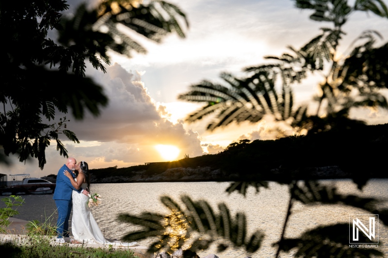 Couple embraces during sunset at Renaissance Wind Creek Curacao Resort wedding celebration