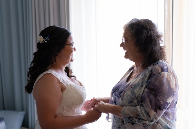 Emotional moment between bride and grandmother before wedding at Renaissance Wind Creek Curacao Resort