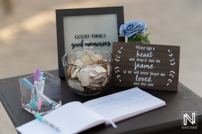 Guests gather to sign a heartfelt memory keepsake at a wedding ceremony in Curacao's scenic Renaissance Wind Creek Resort