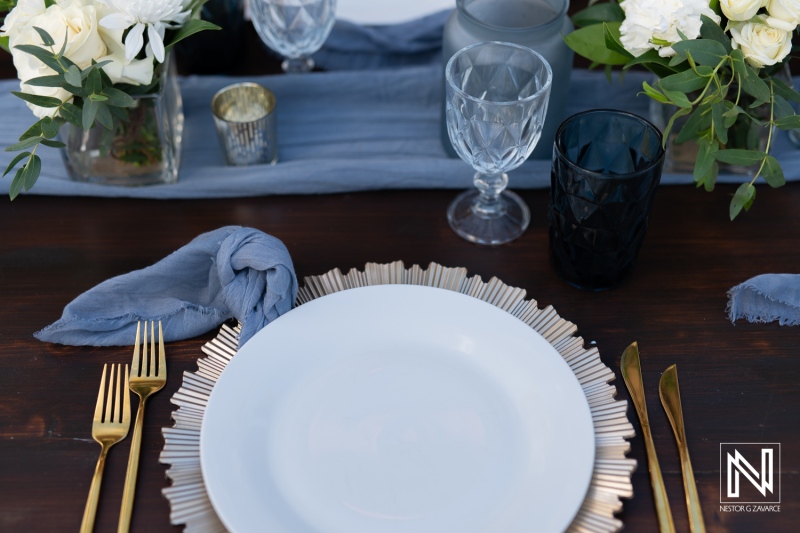 Elegant wedding table setting at Renaissance Wind Creek Curacao Resort with floral decorations and fine dining details