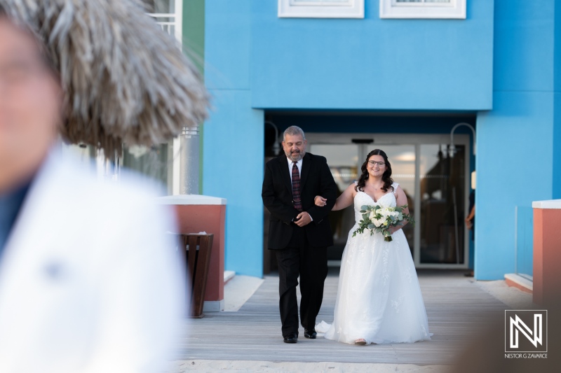 Wedding ceremony in Curacao at Renaissance Wind Creek Resort with beautiful bride and proud father walking down the aisle