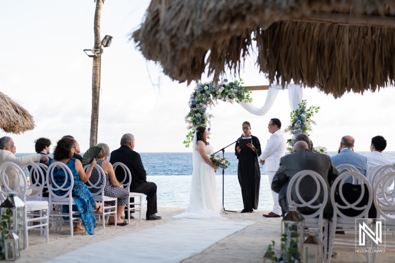 Wedding ceremony on the beach at Renaissance Wind Creek Curacao Resort with ocean backdrop