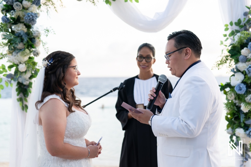 Romantic wedding ceremony at Renaissance Wind Creek Curacao Resort by the beach with beautiful floral decorations