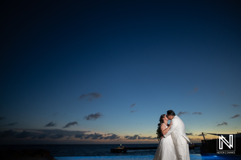 Romantic sunset wedding embrace at Renaissance Wind Creek Curacao Resort with stunning ocean backdrop