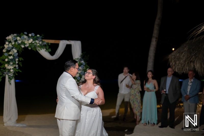 Couple dances under the stars at their wedding ceremony in Curacao, celebrating love and joy at Renaissance Wind Creek Curacao Resort